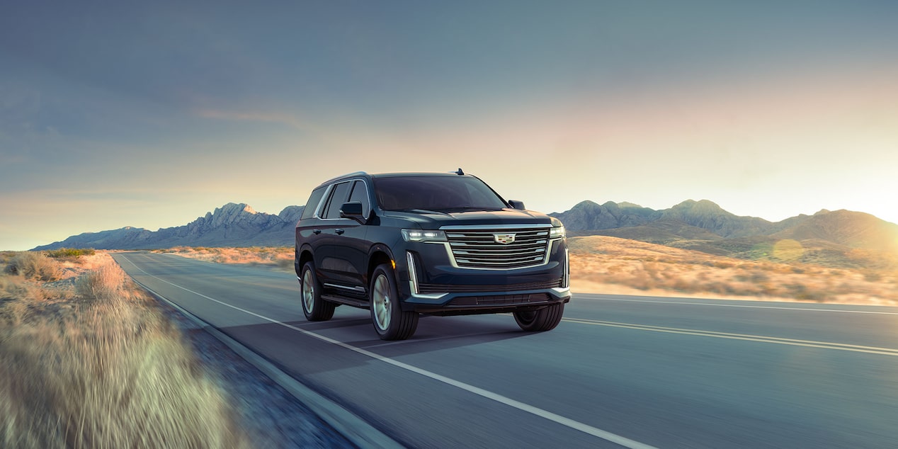 2024 Escalade driving on the road featuring Electronic Limited-Slip Differential.