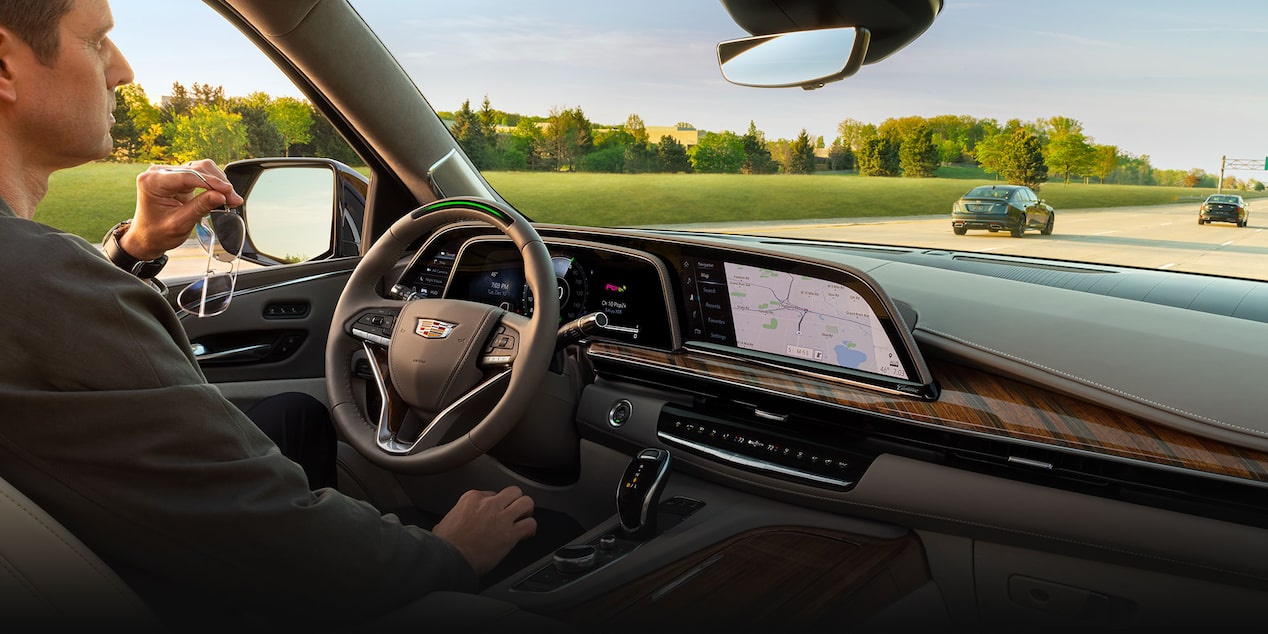 A person driving a 2024 Cadillac Escalade using the Super Cruise feature.