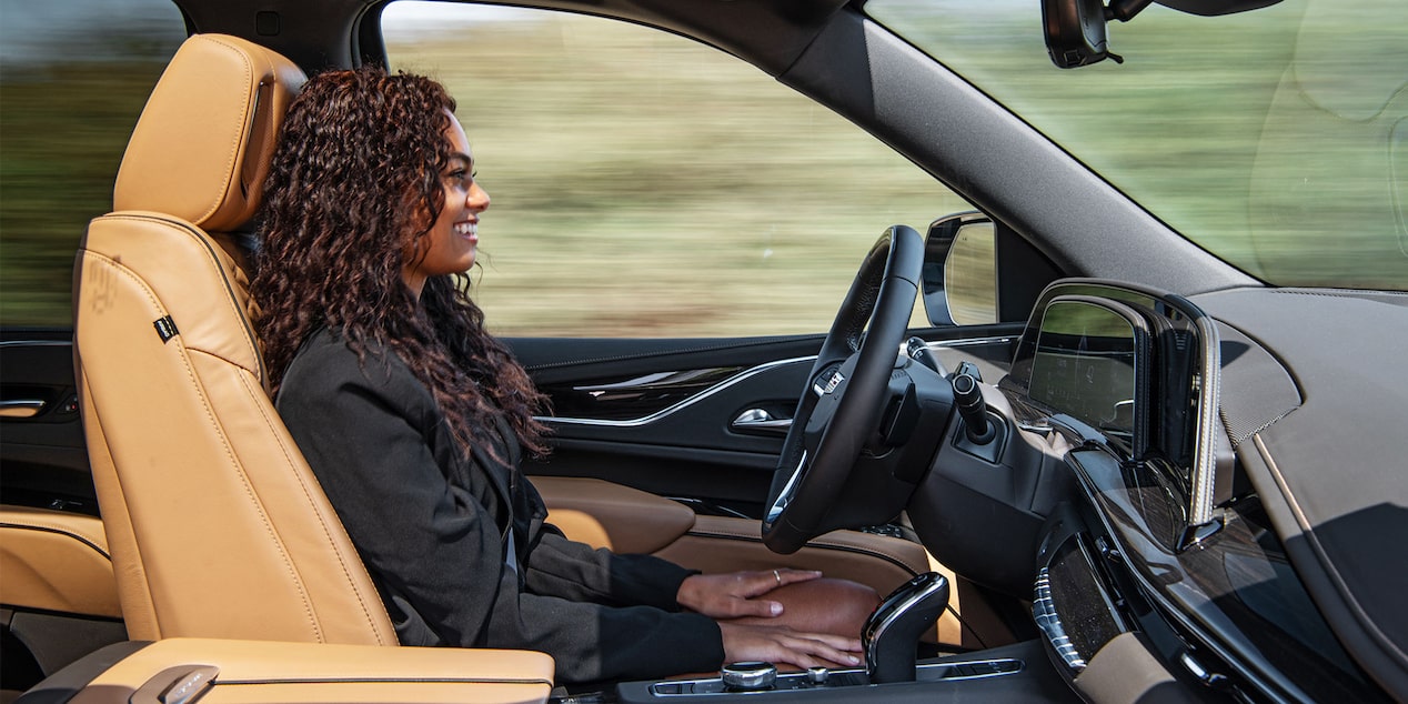 A person driving a 2024 Escalade using the Super Cruise hands-free driver assistance feature.