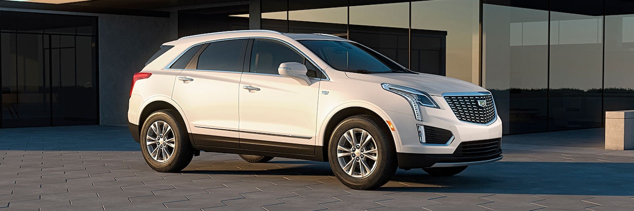 The 2024 Cadillac XT5 in front of a house.