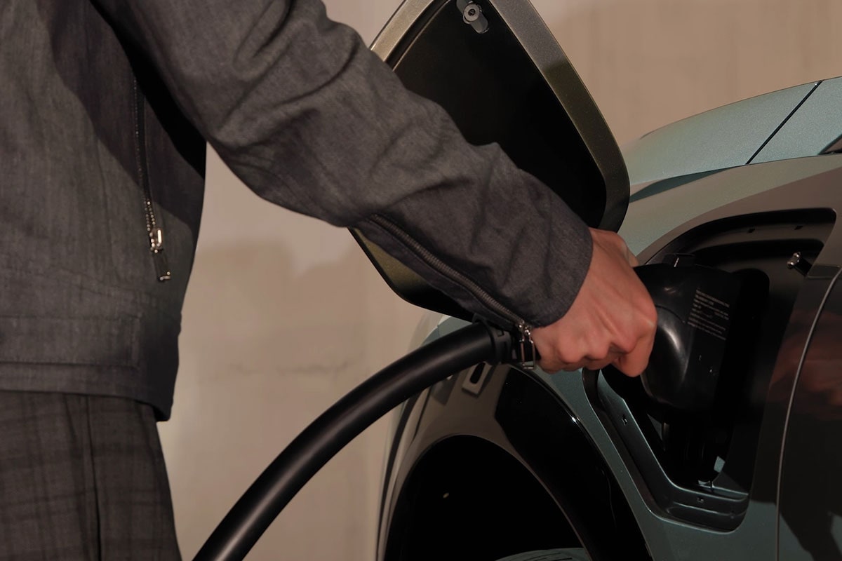 Close up view of a person charging the 2025 Cadillac OPTIQ electric SUV.