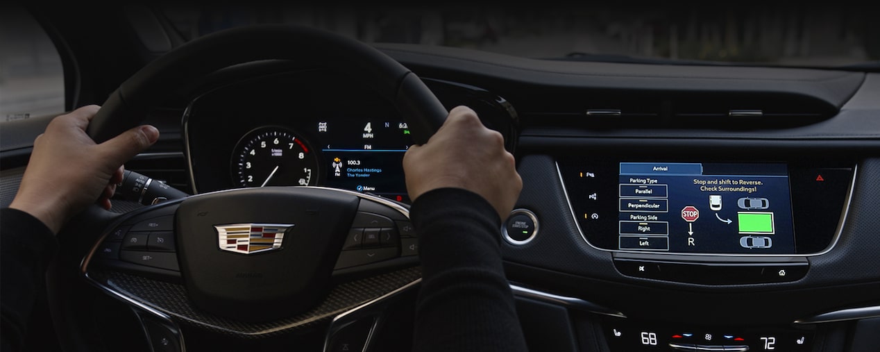 First-person view of a person holding the steering wheel on the 2025 Cadillac XT5 luxury SUV.