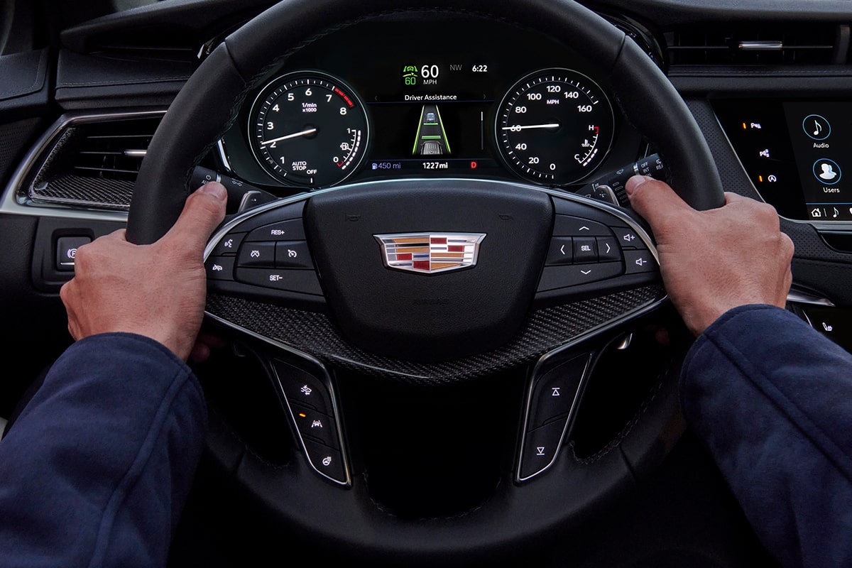 First-person view of a person driving the 2025 Cadillac XT5 luxury SUV.