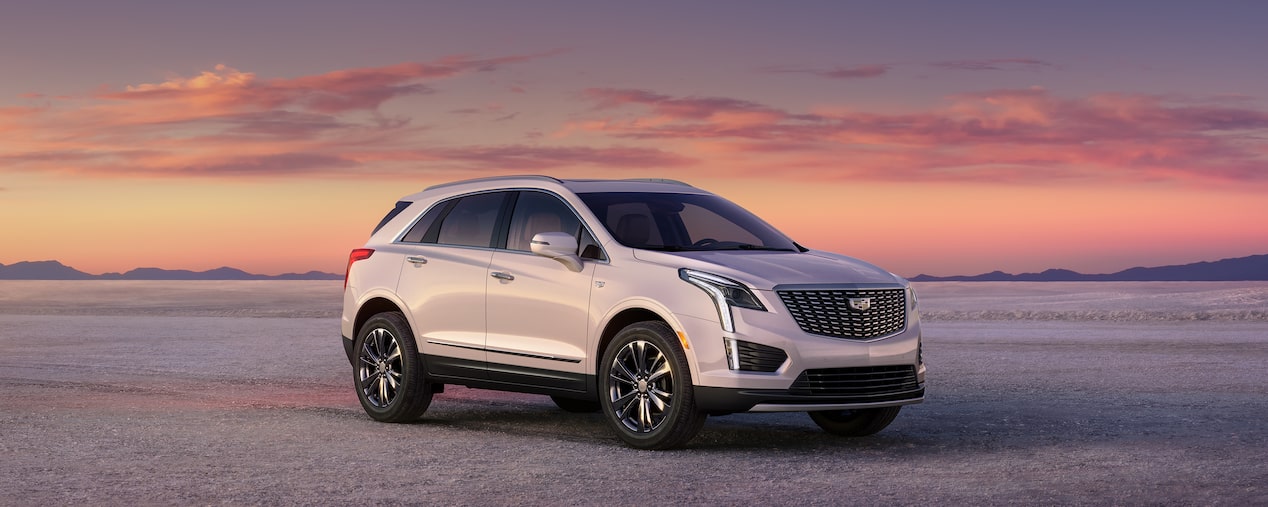 2025 Cadillac XT5 luxury SUV parked outdoors during sunrise.