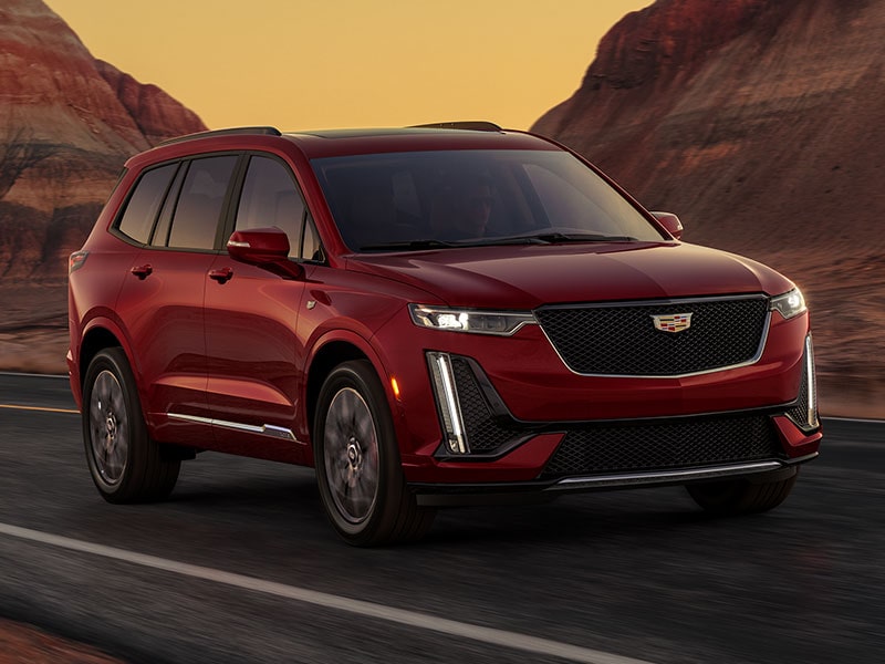 VUS intermédiaire 7 passagers Cadillac XT6 2025 en mouvement seul devant un canyon.