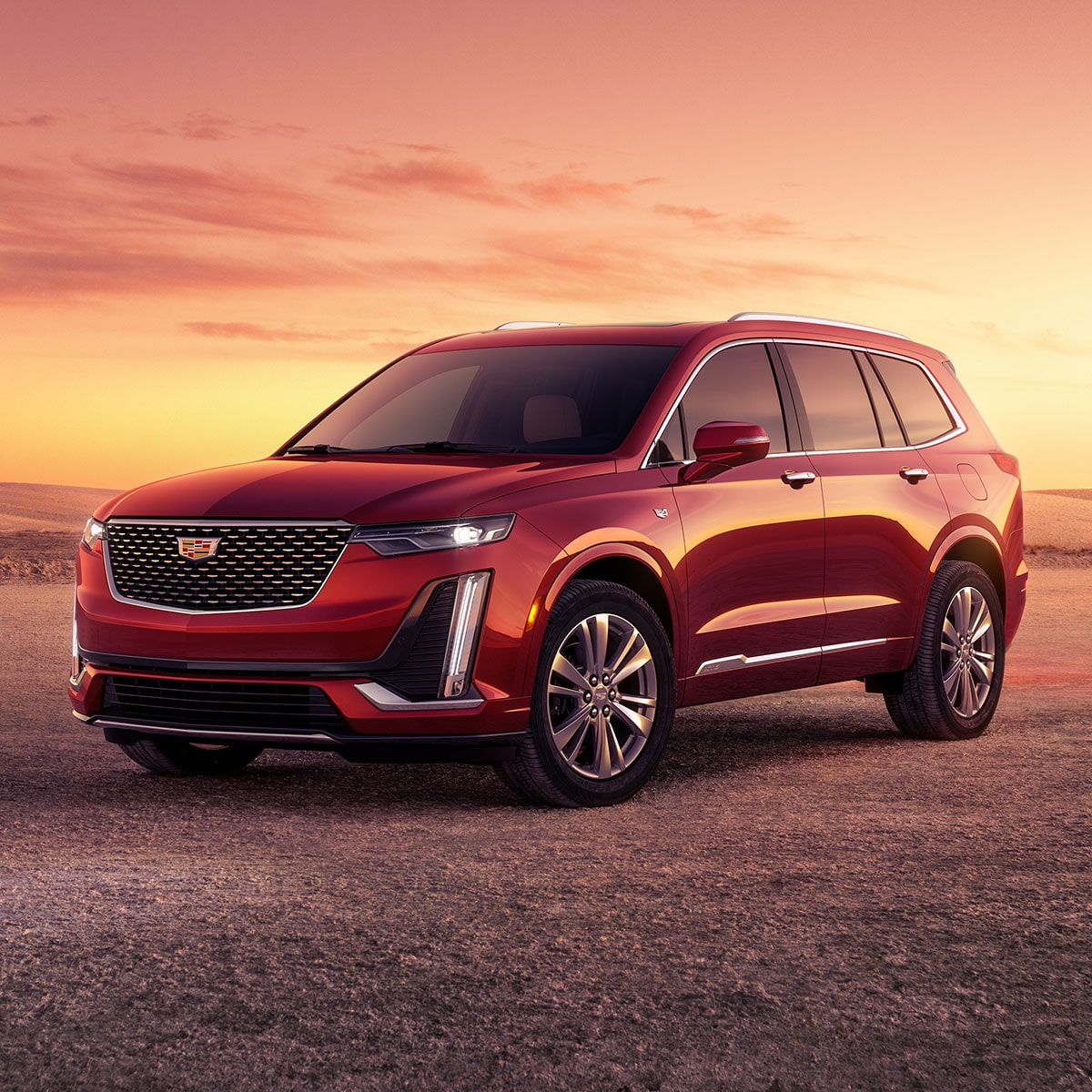 Front-side view of the 2025 Cadillac XT6 mid-size 7 passenger SUV parked outdoors during sunset.