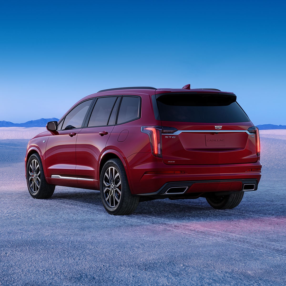 Back-side view of the 2025 Cadillac XT6 mid-size 7 passenger SUV parked alone outdoors.