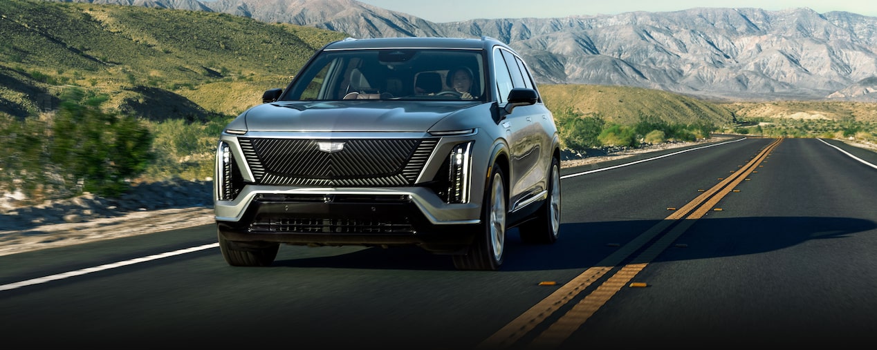 The 2026 Cadillac VISTIQ driving down a mountainside highway.