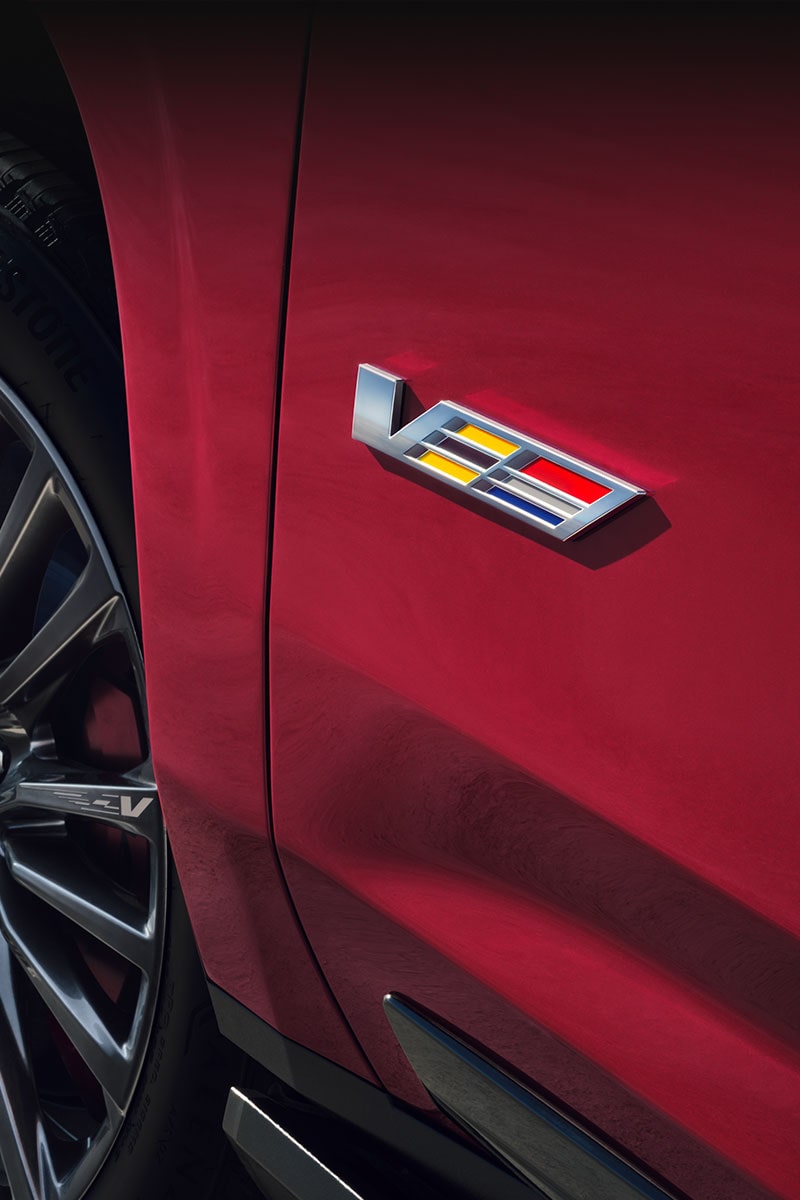 Close-up of the V-Series logo on a Cadillac luxury sedan.