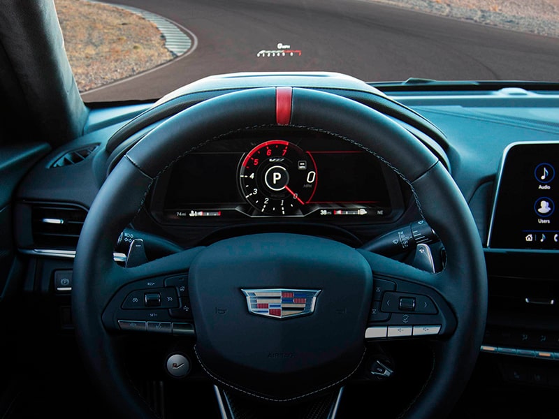 Driver's view of the steering wheel on the 2025 Cadillac CT4-V luxury sports sedan.