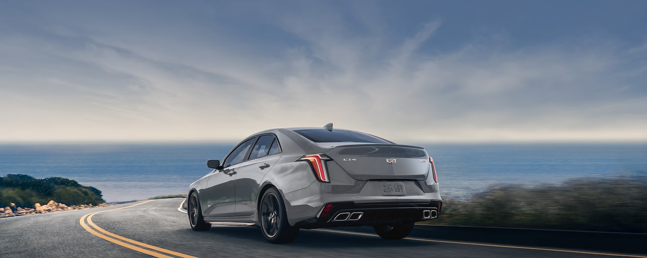 2025 Cadillac CT4-V luxury sports sedan driving alone on a seaside road.