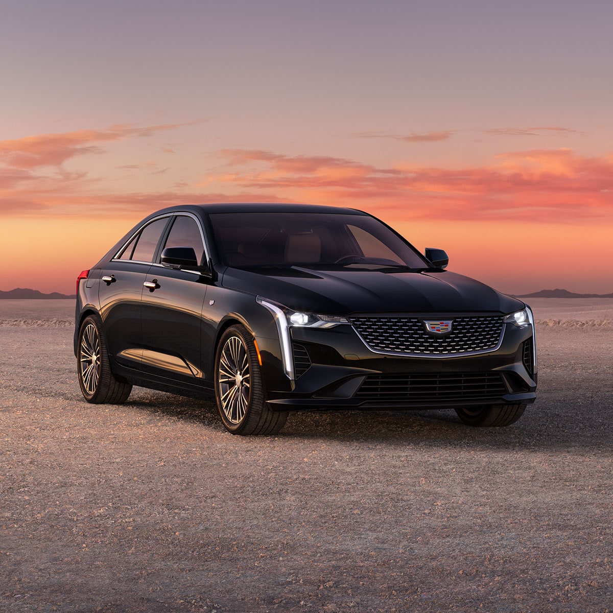 2025 Cadillac CT4 luxury sedan parked alone outside during sunset.