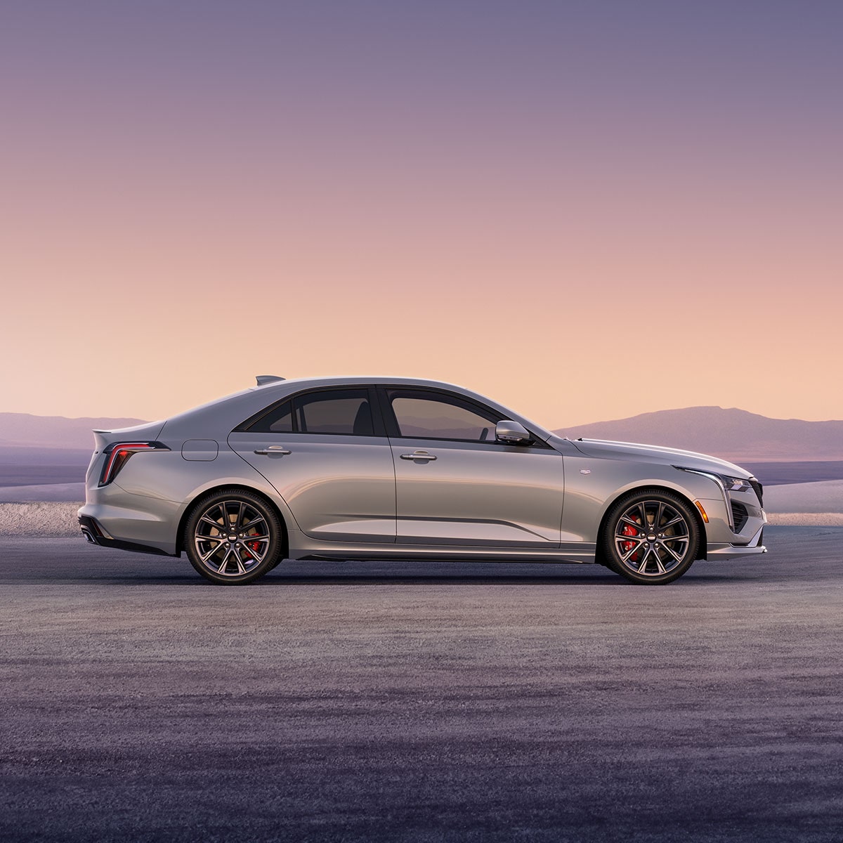 Side view of the 2025 Cadillac CT4 luxury sedan parked alone outside.