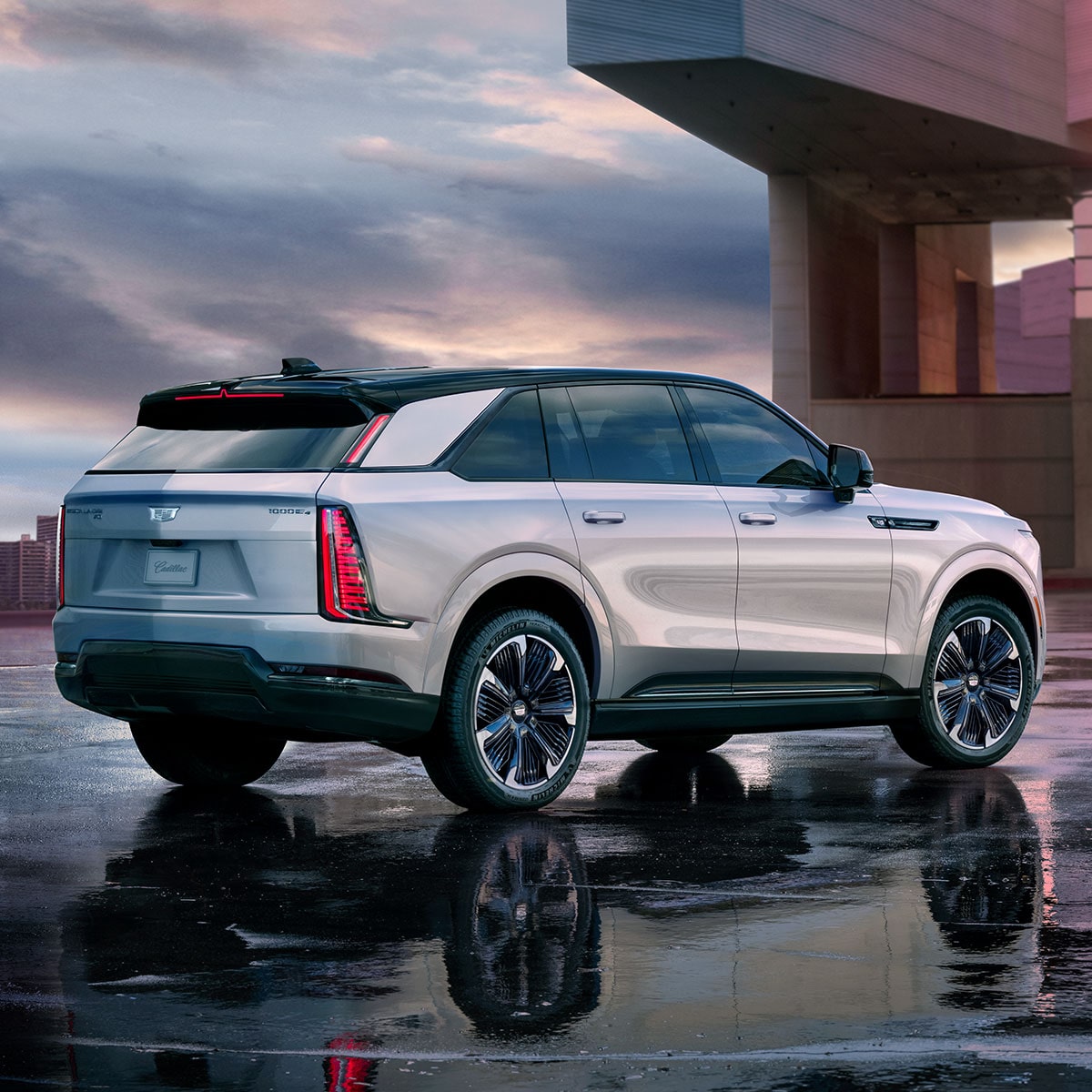  2025 Cadillac Escalade IQ electric suv parked on wet flooring during a cloudy weather.