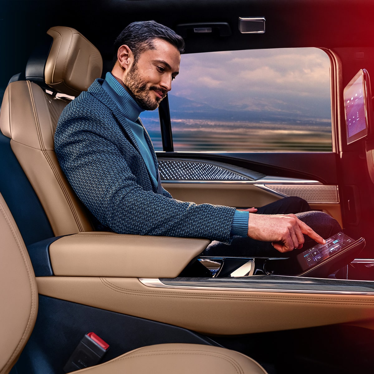 A person pressing a button in the Rear Command Centre of the 2025 Cadillac Escalade IQ electric suv.