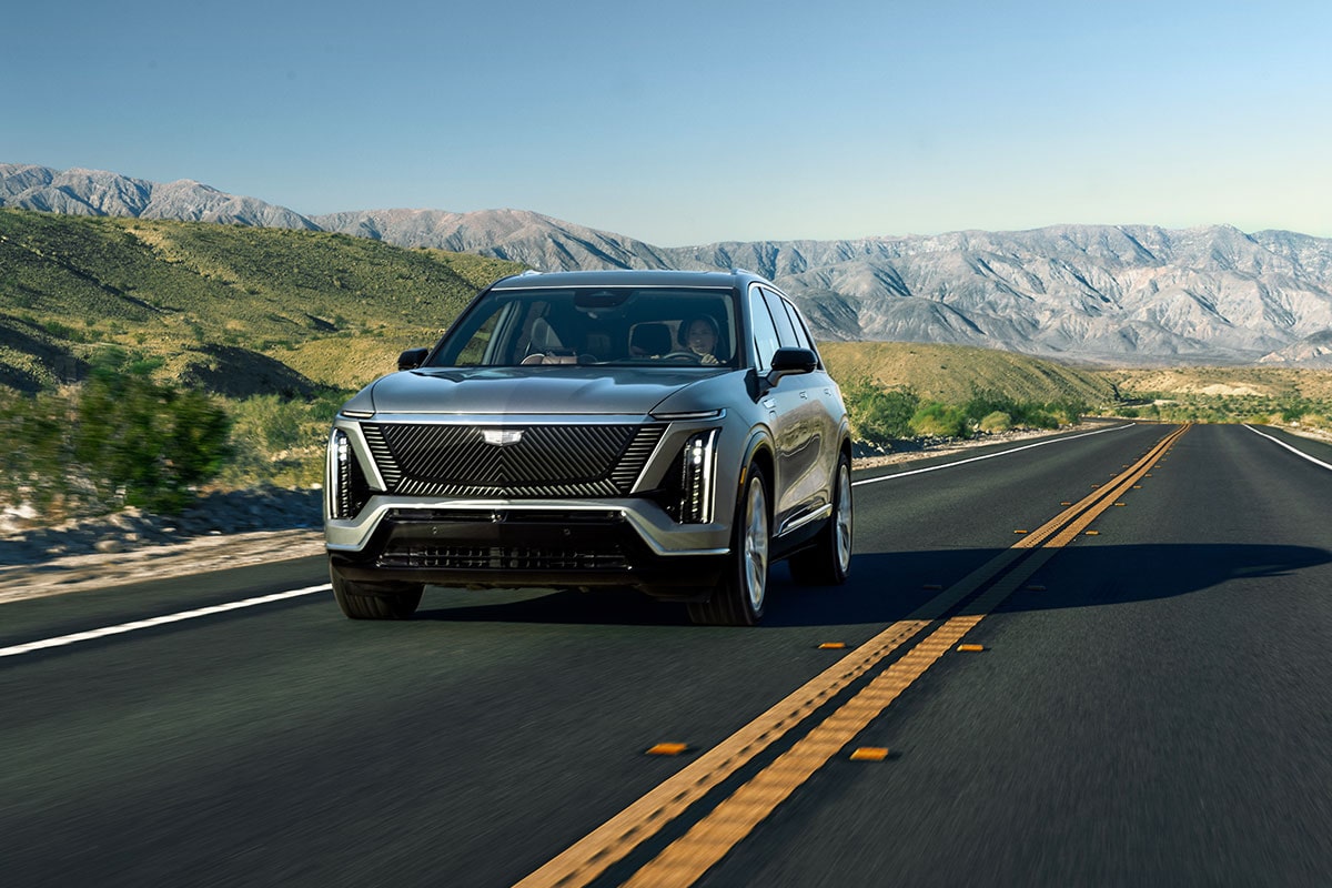 The 2026 Cadillac VISTIQ driving down a mountainside highway.