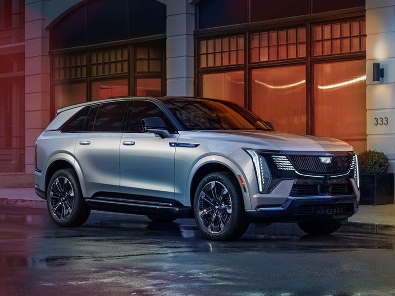 The Cadillac Escalade IQ parked on a pavement beside a building.