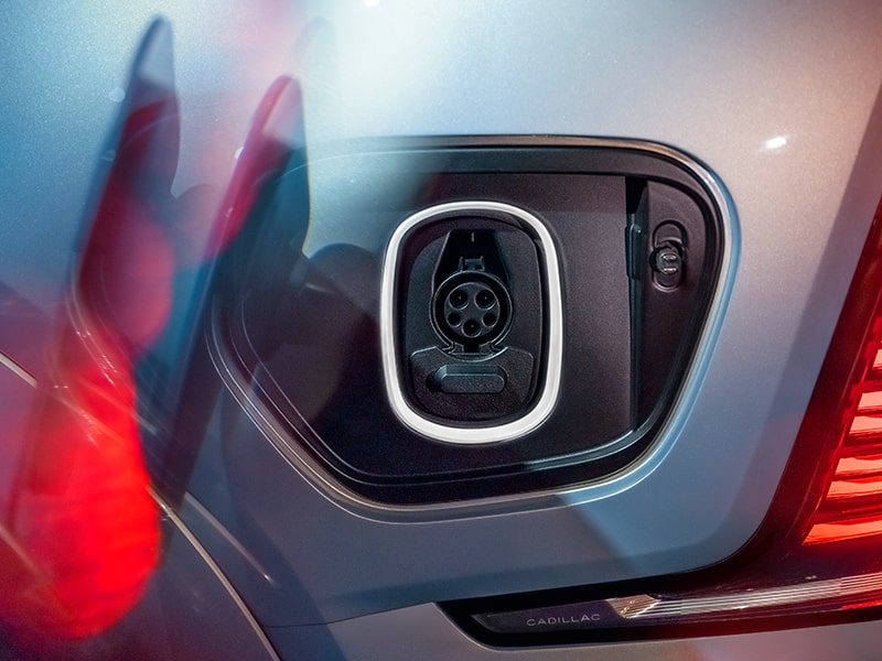 Zoomed view of the electric charging port of the Cadillac Escalade IQ.