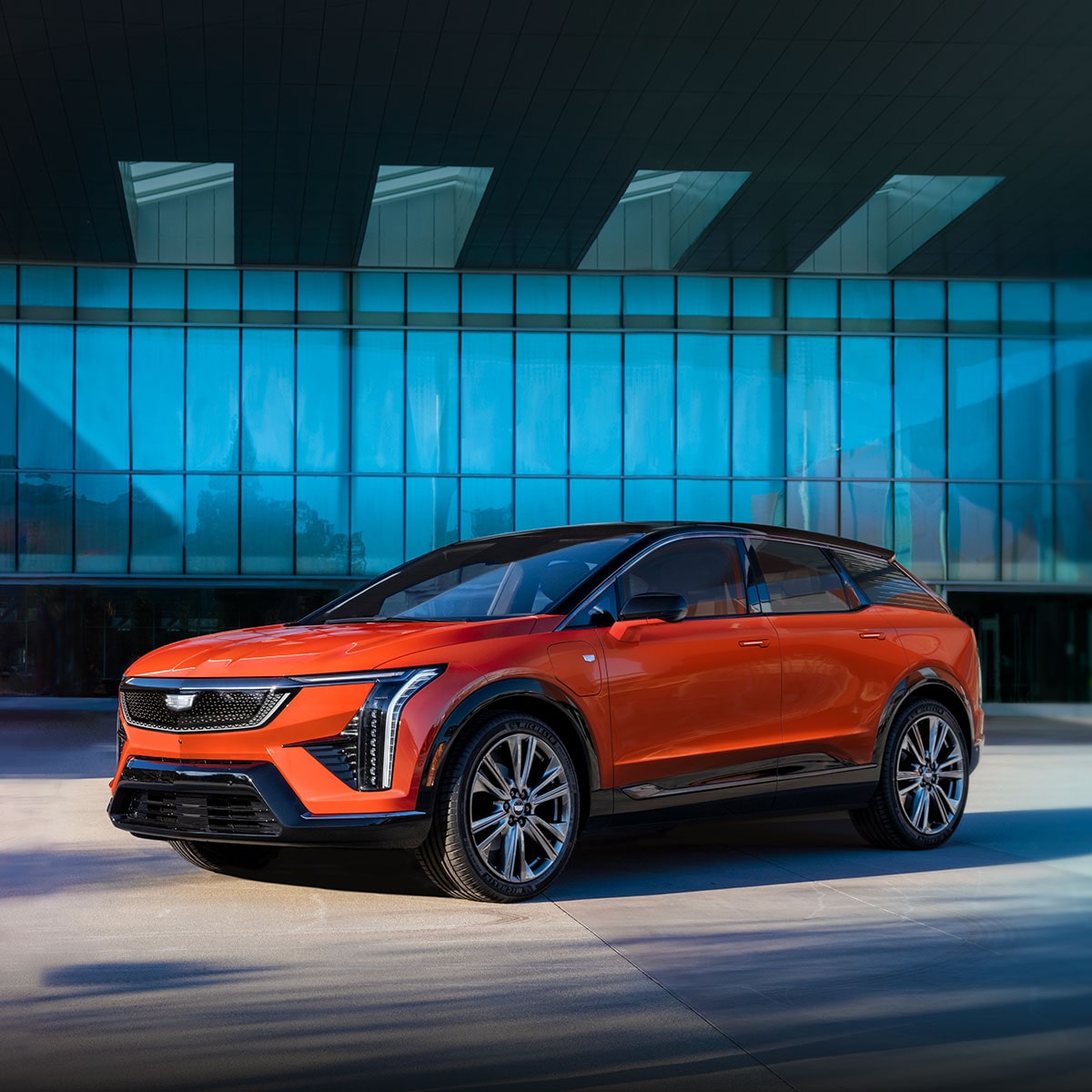 Pre-production model of the 2025 Cadillac OPTIQ parked on a showroom.