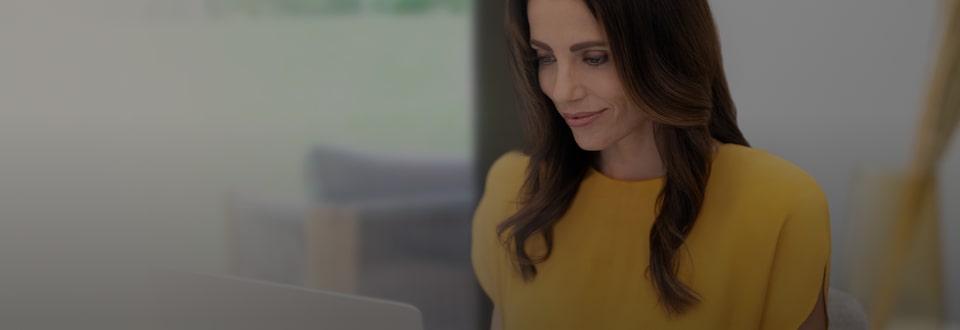 A person looking at a laptop eligible for GM's Student Bonus Program.