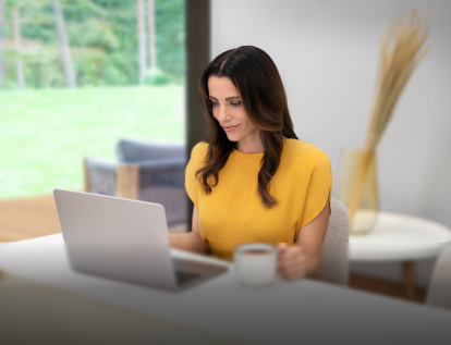 A person looking at a laptop eligible for GM's Student Bonus Program.