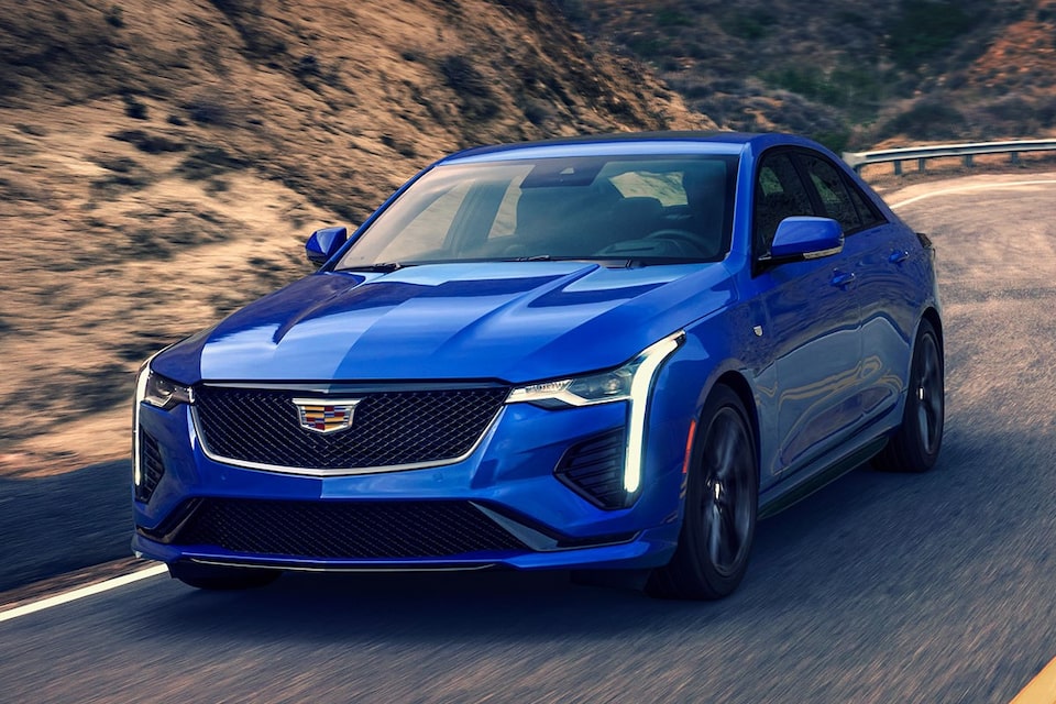 2025 Cadillac CT4 luxury sedan driving alone on a hillside road.